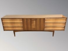 A 20th century Elliotts of Newbury teak and walnut low sideboard,