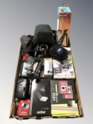 A group of modern cameras and photography items,