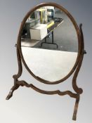 A mahogany oval dressing table swing mirror, height 55 cm.