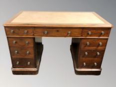 A Victorian mahogany nine drawer twin pedestal desk,