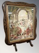 A carved walnut and tapestry fire screen depicting the last supper,