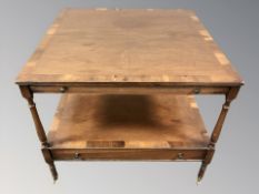 A reproduction yewwood two tier occasional table fitted drawers,