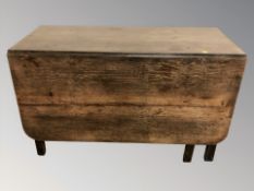 A 19th century oak drop leaf dining table,