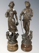 A pair of patinated French spelter figures 'Berger' and 'Bergere', height 40 cm.