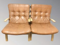 A pair of Danish bentwood and tan leather lounge armchairs,