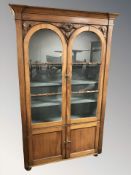A Victorian walnut glazed double door bookcase,