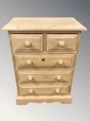 A modern pine five drawer chest,
