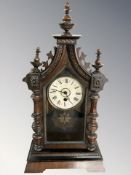 A 19th century Junghans beech mantel clock with pendulum and key,