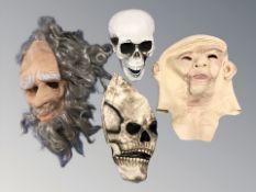 An articulated model of a human skull and a group of grotesque masks