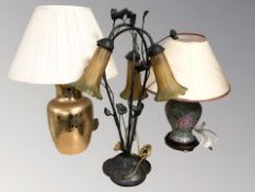 An Art Nouveau style metal table lamp and two further modern ceramic lamps