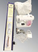 A Singer feather weight electric sewing machine with lead and pedal and an artists's sketch easel