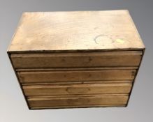 An oak and plywood four drawer table top chest,