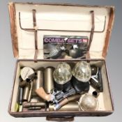 A vintage luggage case containing inert brass shells and bullet casings, toy pistol and grenades,