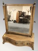 A Victorian mahogany satinwood inlaid serpentine fronted dressing table mirror, width 48 cm,