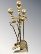 A brass fire companion set on stand