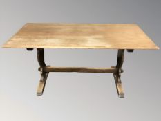 An oak 5' refectory dining table and a set of four wheel backed chairs