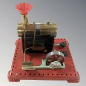 A Mamod live steam boiler with piston.