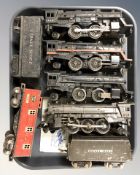 A group of 20th century tin plate locomotives and passenger cars including Lionel.
