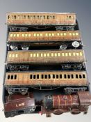A group of 20th century tin plate locomotives and passenger cars.