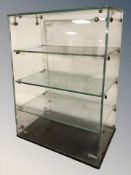A glass collector's display stand, width 37 cm.