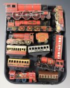 A group of 20th century tin plate locomotives and passenger cars including wind up examples.