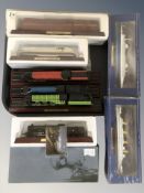 A group of scale model locomotives on plinths, Atlas Editions warship model,