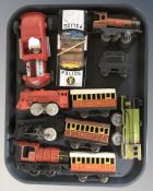 A group of tin plate locomotives and passenger cars, a Marx Toys hotrod car, police car, etc.