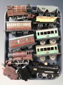 A group of tin plate rolling stock including locomotives, passenger cars.