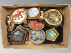 A group of painted plaques and crests