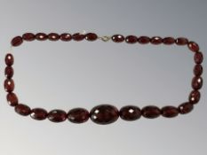 A string of amber/Bakelite beads with gold clasp