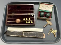 A hygrometer in box, slide rule, Chinese medicine balls,