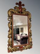 An antique style carved wooden mirror, 45 cm x 84 cm.