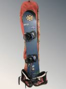 An snow board in carry bag and a pair of boots