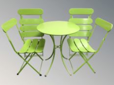 A modern painted metal circular table and four matching chairs