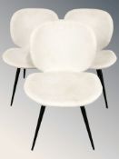 Three Danform chairs in oatmeal fabric on enameled metal tapering legs.