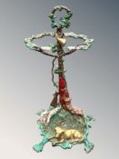 A painted metal stick stand surmounted by a gun dog,