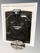 A Newcastle Falcons Northern Rock rugby shirt with team signatures and a Gilbert rugby ball also