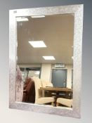 A contemporary bevelled mirror in a silvered frame, 72 cm x 99 cm.