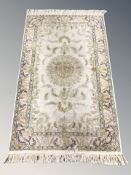 A Kashmir silk rug, 170 cm x 94 cm.