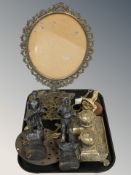 An ornate brass picture stand, trivet, desk stand, pair of patinated metal figures of harvesters,