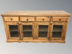 A mango wood sideboard, 180 cm x 46 cm x 90 cm.