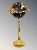 A brass gemstone floor standing globe, height 94 cm.