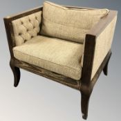 A stained oak framed armchair, 80 cm W x 70 cm D x 72 cm H.