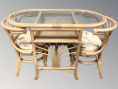 A bentwood glass topped oval table and a pair of stowaway chairs, width 110 cm.