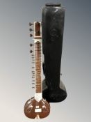 A sitar, length 123 cm, in hard carry case.