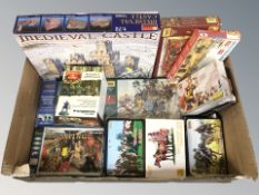 A group of tabletop miniatures including medieval castle model, Roman soldiers, vikings, etc.
