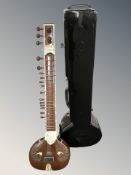A sitar, length 123 cm, in hard carry case.