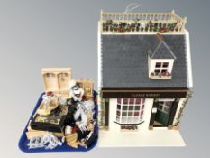 A contemporary doll's house shop, marked 'Clarks Bakery', with furnished interior,