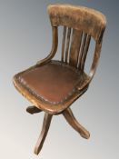 An Edwardian oak swivel desk chair