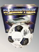 A Newcastle United football with team signatures and a St. James Park scale model in box.